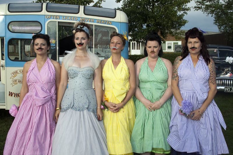 bride and bridesmaids wearing mustaches 