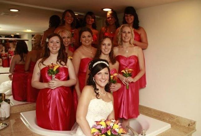 A bride and her bridesmaids in the bath