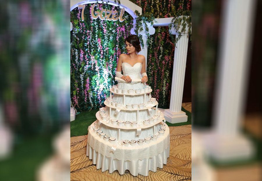 A bride wearing a cake wedding dress