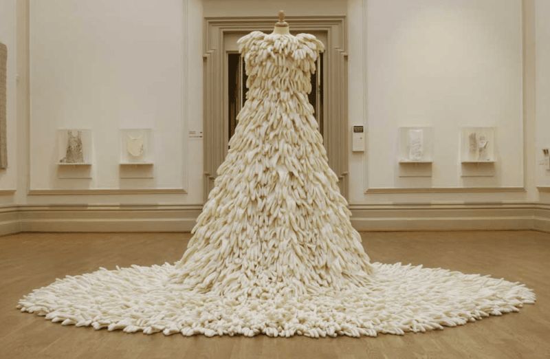 A wedding dress made completely out of white gloves 