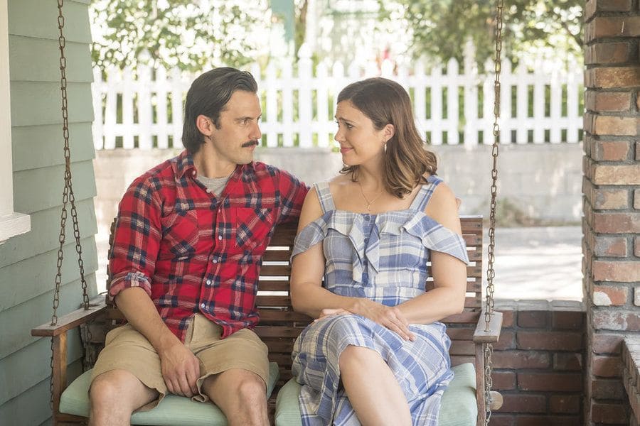 Mandy Moore and Milo Ventimiglia sitting on the porch swing in This Is Us.