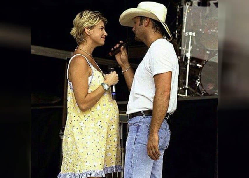 Tim McGraw and Faith Hill perform on stage, Hill is pregnant with their daughter Gracie.