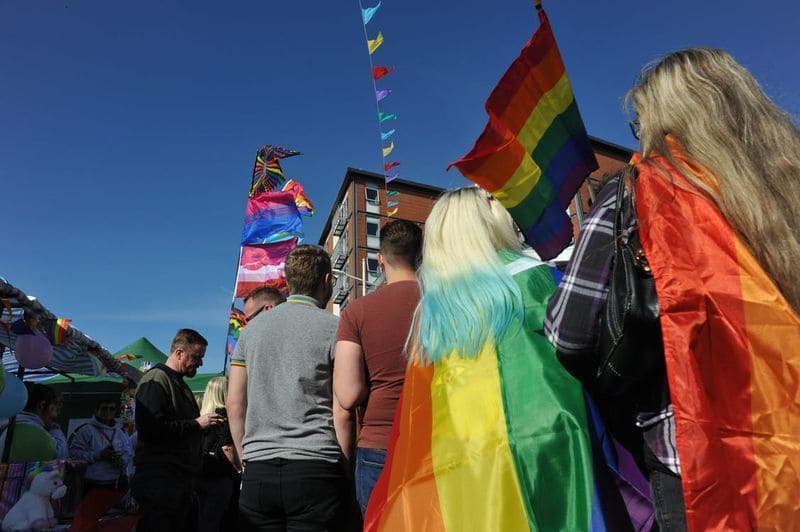 LGBT People walking at a pride parade.