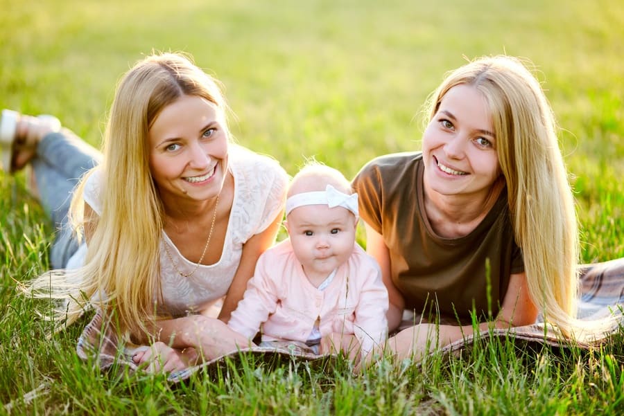 Stock photo of two young mothers in the park their baby.
