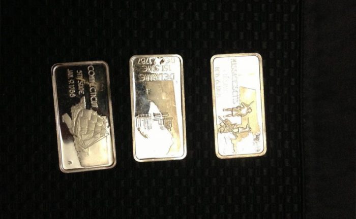 Bars of silver in mint condition with Massachusetts, Delaware, and Connecticut written on them