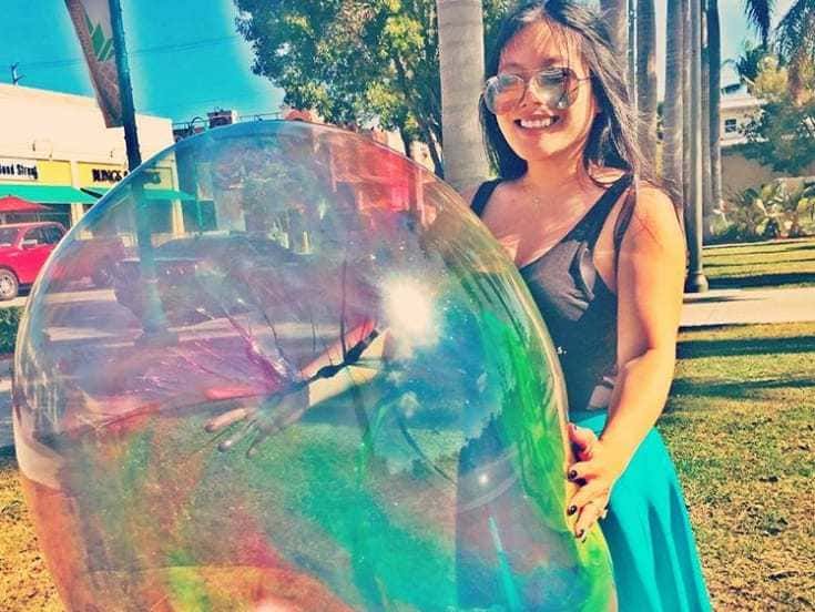 Girl with a giant plastic bubble.