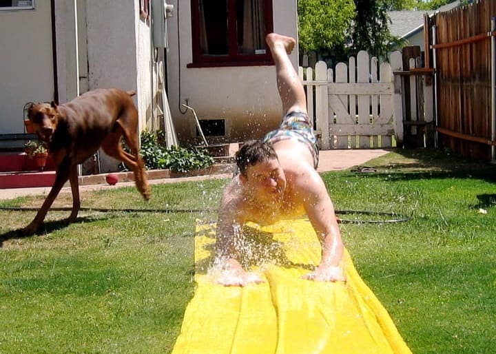 A kid playing with Slip ‘n Slide.