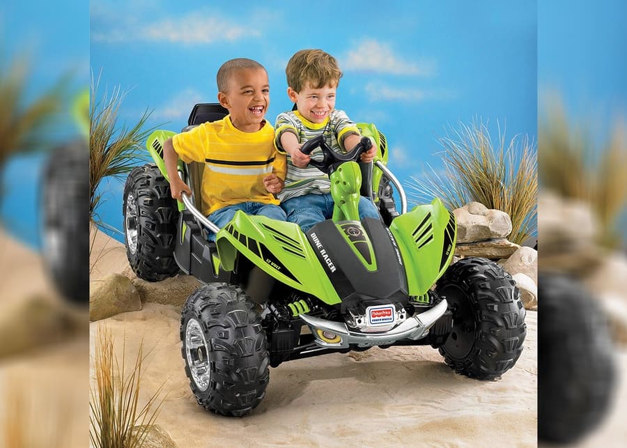 Boys riding on the This Fisher-Price Power Wheels car. 