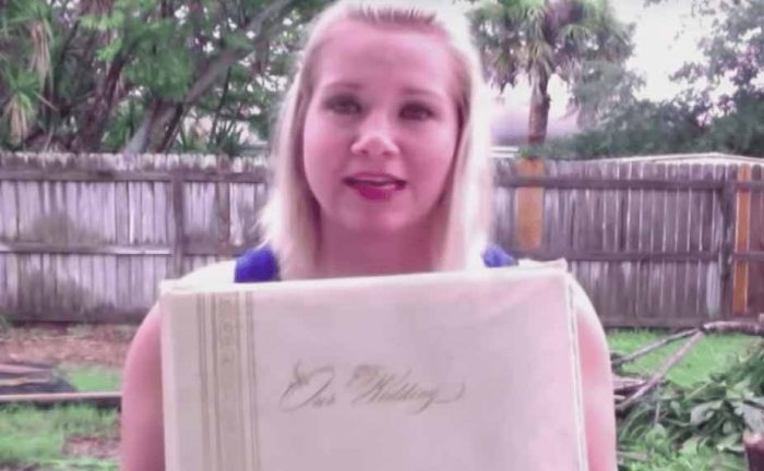 Megan holding up the wedding album