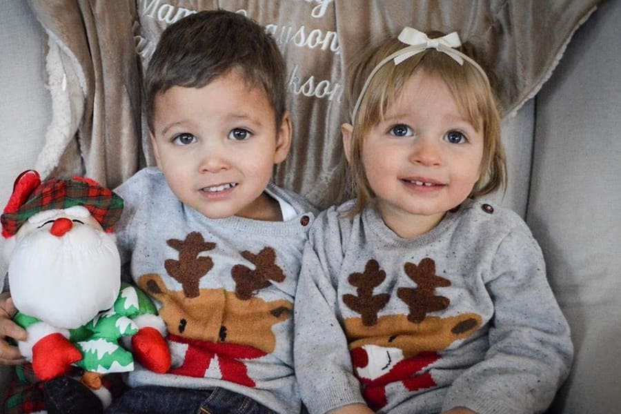 Katie’s two children, Grayson and Hannah, wearing Christmas sweaters.