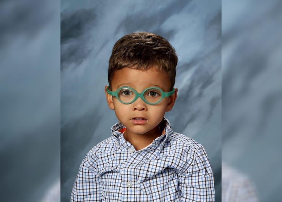 Grayson in his first school portrait, wearing glasses.