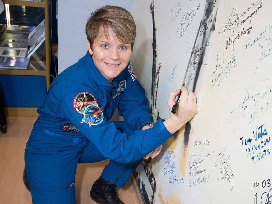 NASA astronaut Anne McClain drawing on a board