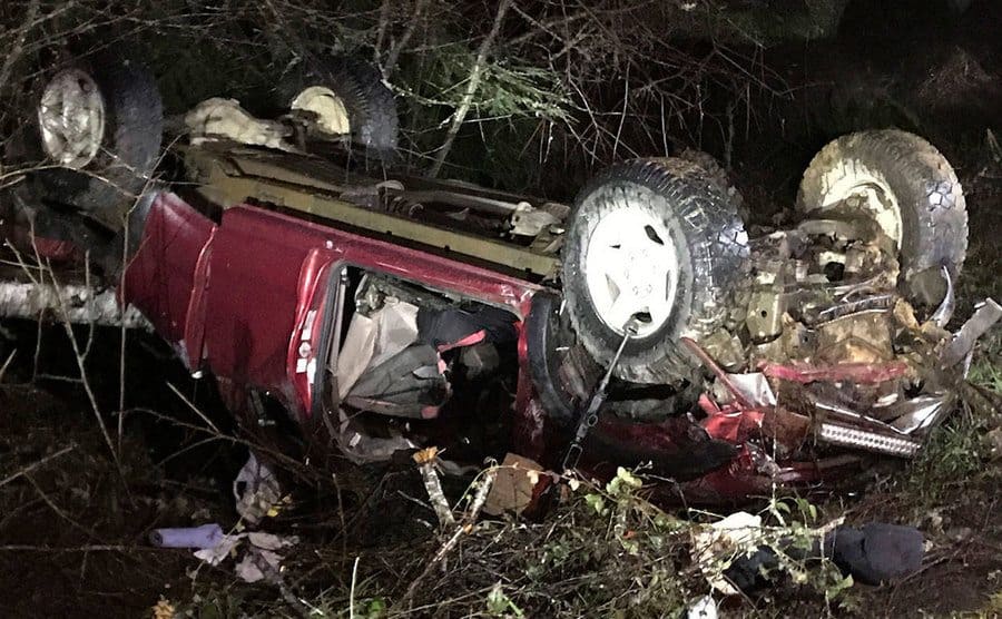 A photograph of their red car flipped upside down