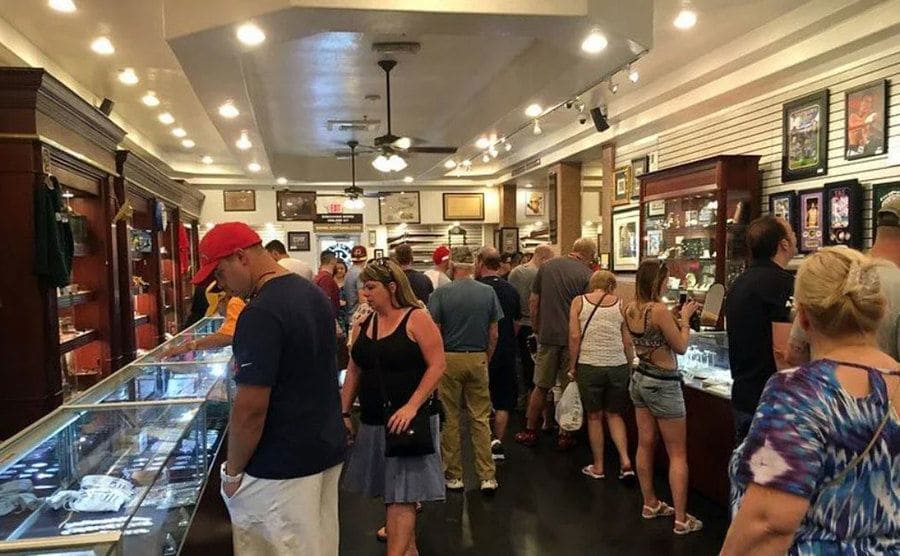 A photograph of people walking around an auction house