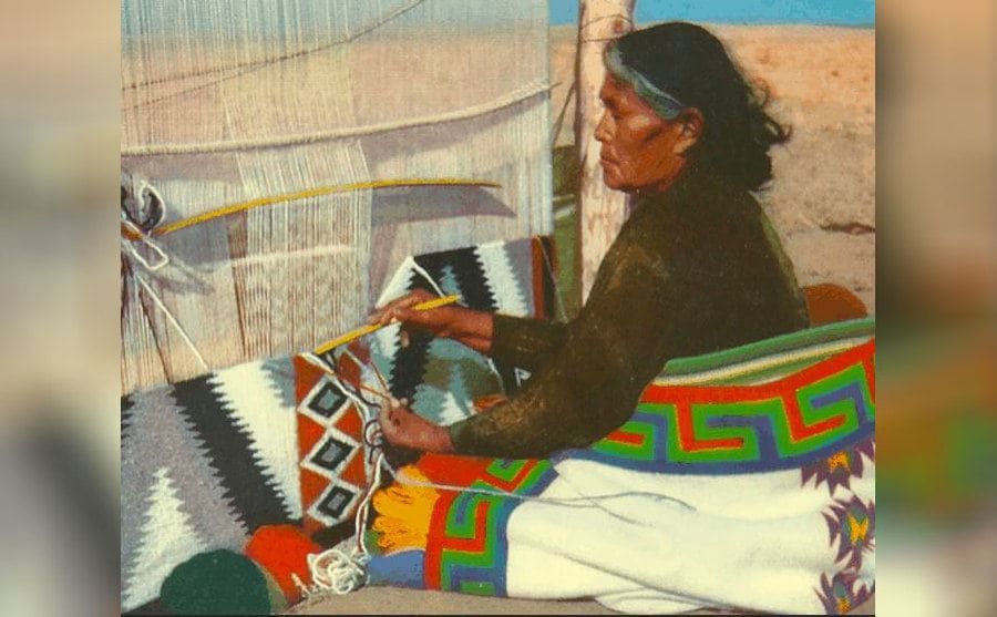 A man weaving a Navajo blanket