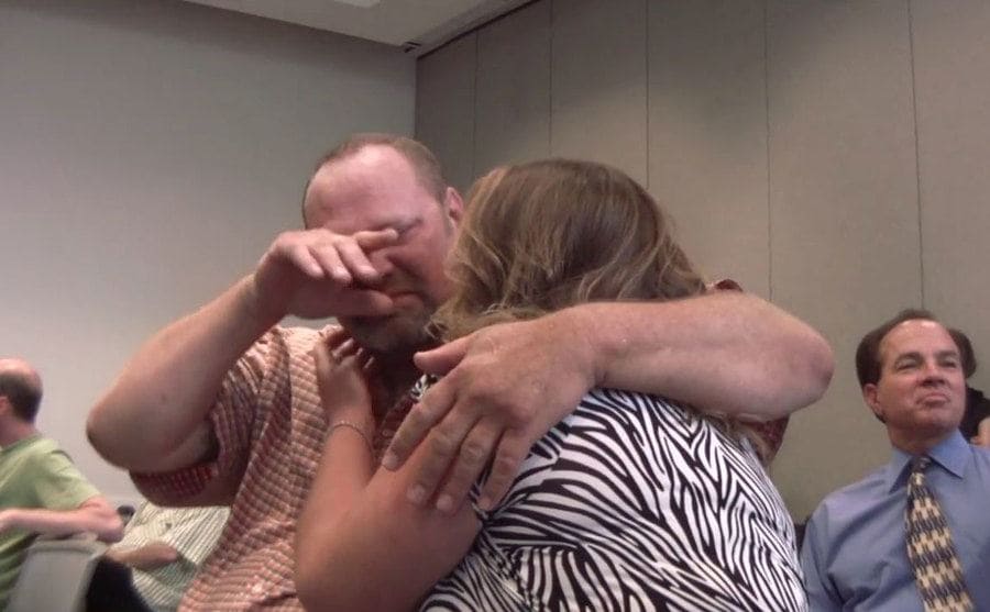 Loren crying while his wife hugs him