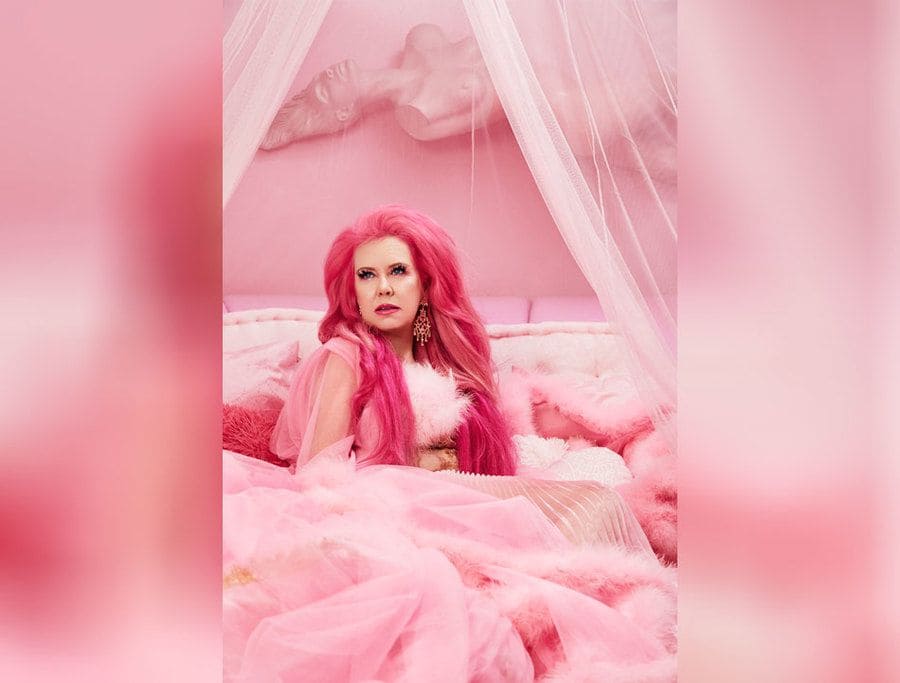 Kitten Kay Sera sitting on her all pink bed while wearing all pink