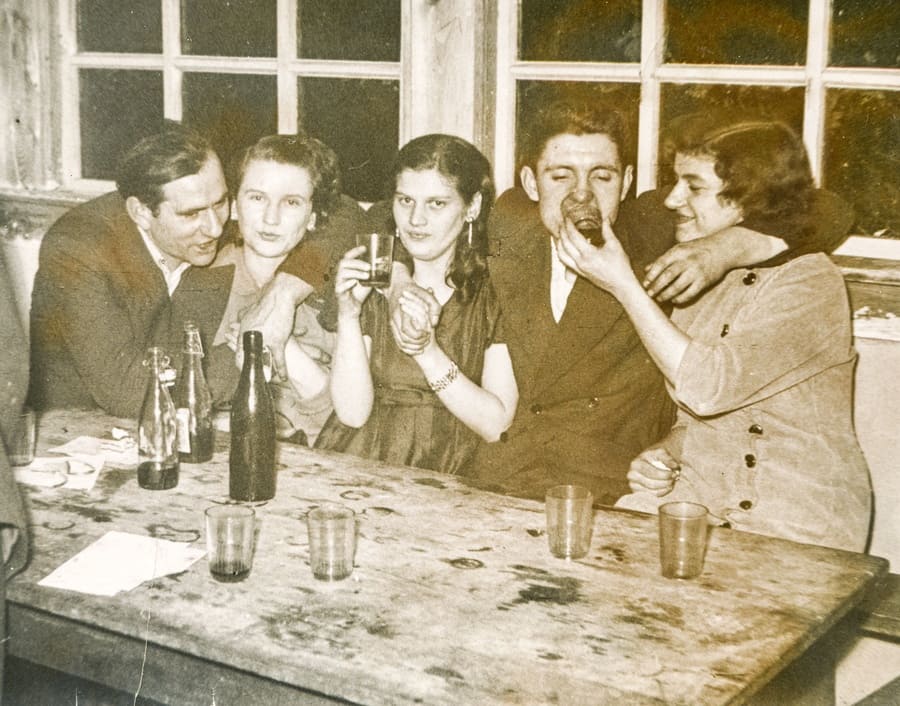 A vintage photograph of young people partying and drinking alcohol together