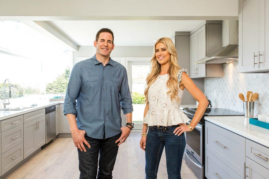Tarek and Christina are posing in a kitchen for a promotional shot for Season 8.