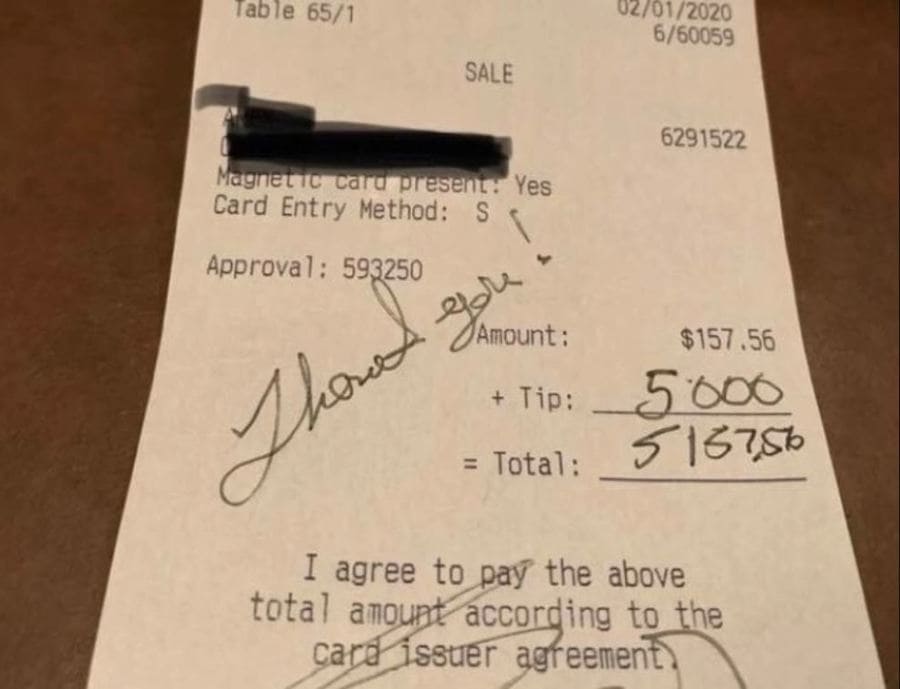 A photograph of a receipt with a $5000 tip