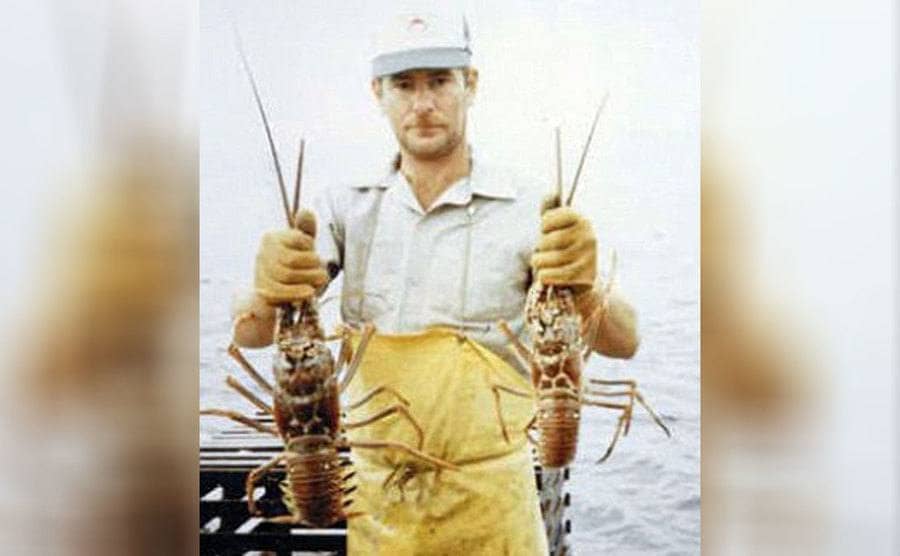The real Terry Symansky holding lobsters on a fishing boat 