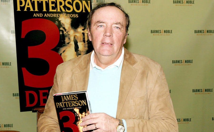 James Patterson holding his new book at the time, '3rd Degree,' in 2004