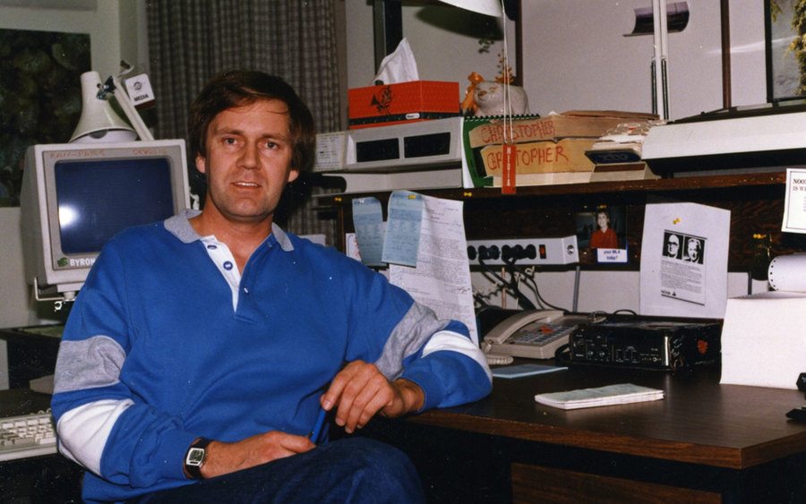 Bryon Christopher sitting at his desk 