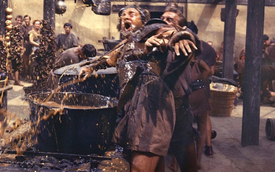 Kirk Douglas pushing Charles McGraw into the large pot of soup in ‘Spartacus.’