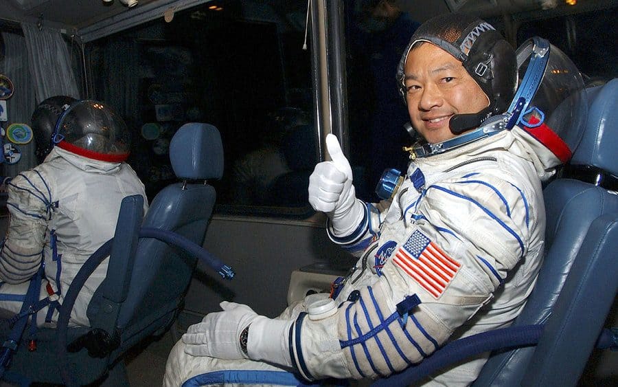 Leroy Chiao giving a thumbs up on the ride from suiting up to the launch pad with his crewmates 