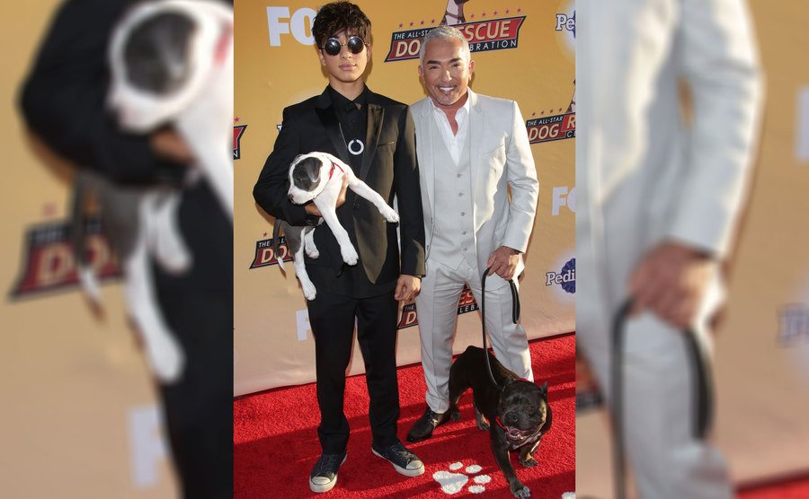 Cesar Millan and Calvin Millan on the red carpet with their dogs