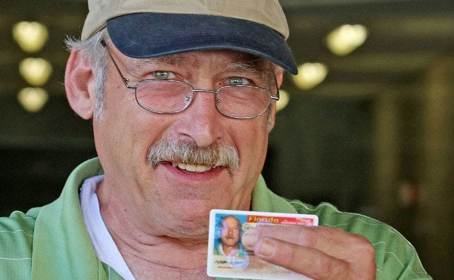 Benjaman Kyle holding up his Florida drivers license 