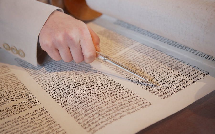 Hand of a boy reading the Torah at a Bar Mitzvah