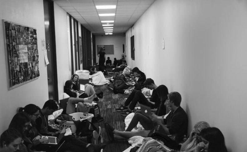Students sitting in the hallway of their dorms 