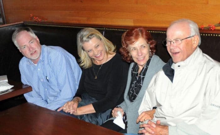 Karen, Denis, Jean, and her husband sitting at a booth in a restaurant