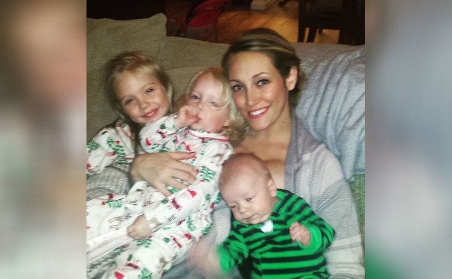 Myka with her three oldest children and one of them sucking their thumb 
