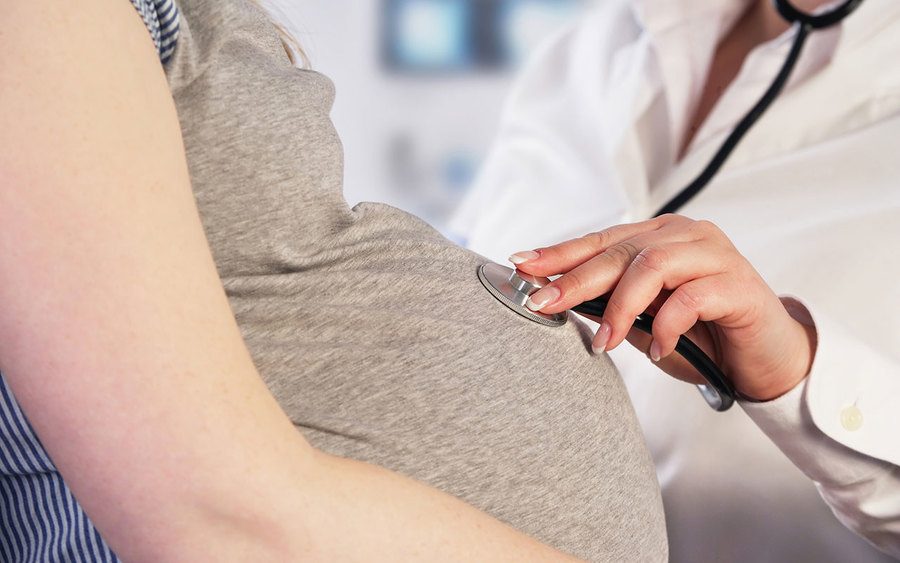 A doctor examining a pregnant woman 