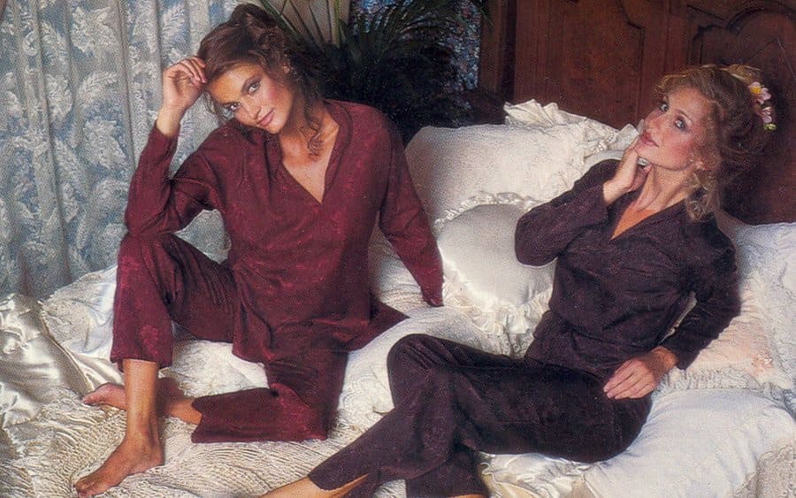 A photograph of two women in satin pajama sets 