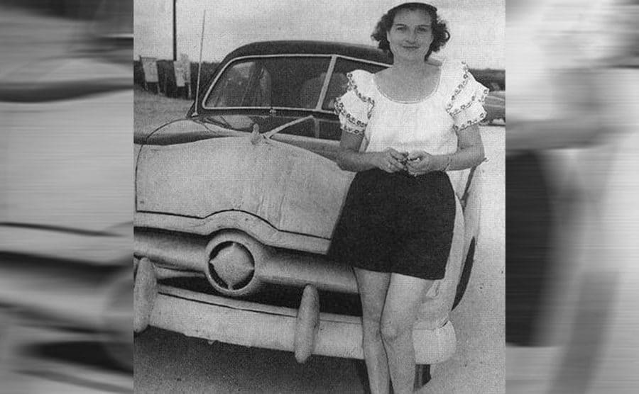 Sara Christian in front of her car