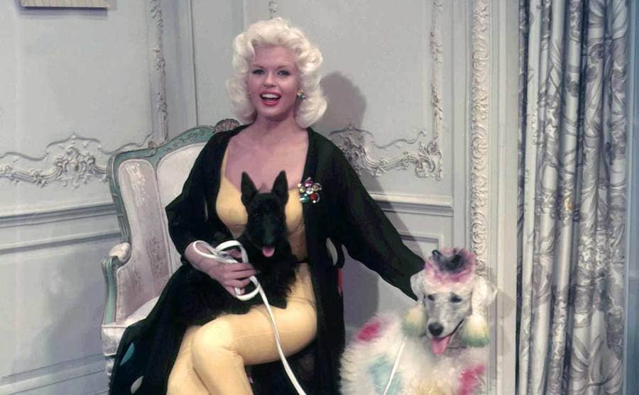Jayne Mansfield with her two pet poodles in a candid shot 