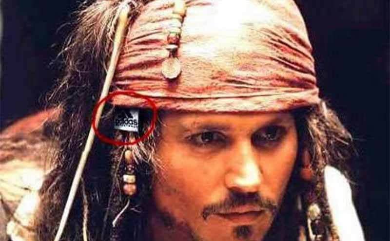 Johnny Depp with an adidas tag sticking out of his head scarf 