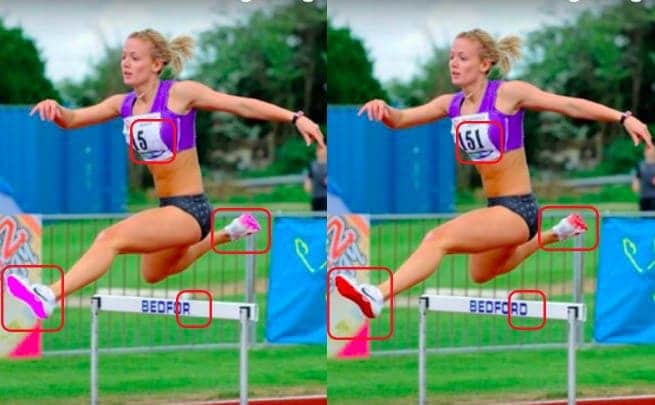 A woman jumping over a hurdle on a running track