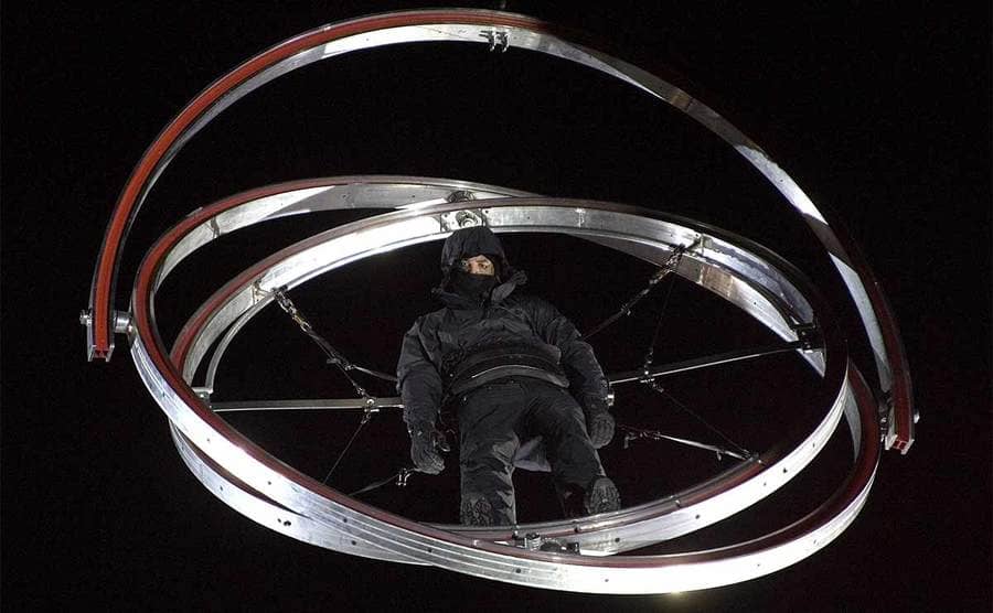 David Blaine mid-air in a three-ringed gyroscope above Times Square 
