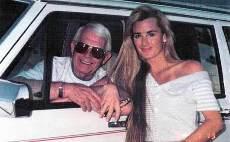Ken Richards sitting in the driver’s seat while Kyle Richards stands outside of the car posing for a photograph 