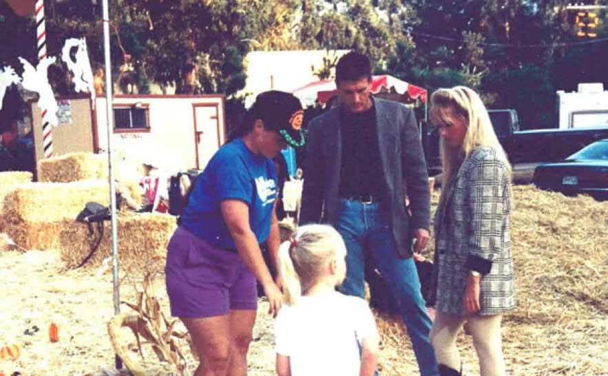 John Collett and Kim Richards with her daughter in a pumpkin field 