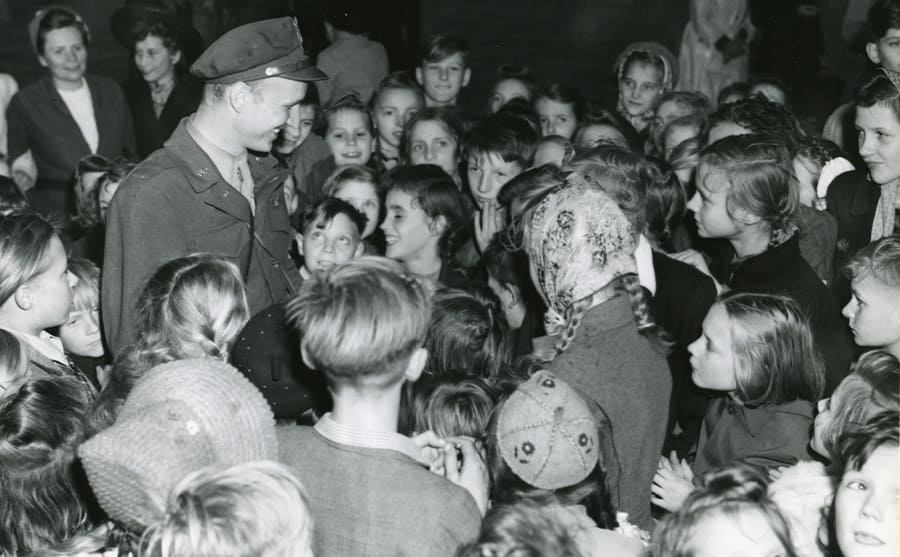 Lt. Gail Halvorson surrounded by children in the streets of Berlin 