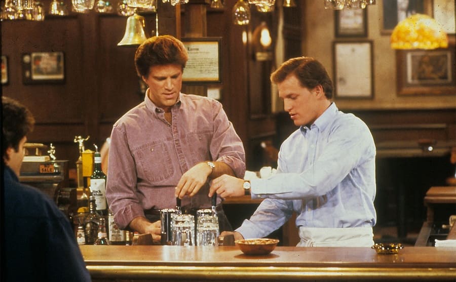Ted Danson and Woody Harrelson behind the bar on the set of Cheers 