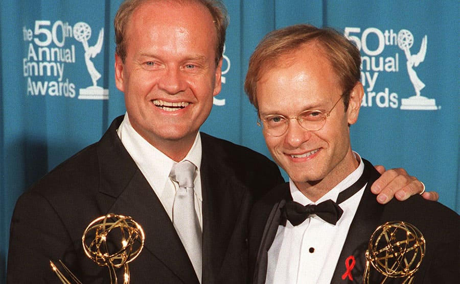 Kelsey Grammer and David Hyde Pierce holding their awards at the Emmys in 1998
