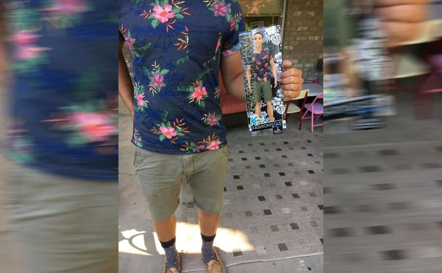 A guy wearing the same blue and pink floral shirt as a Ken doll 