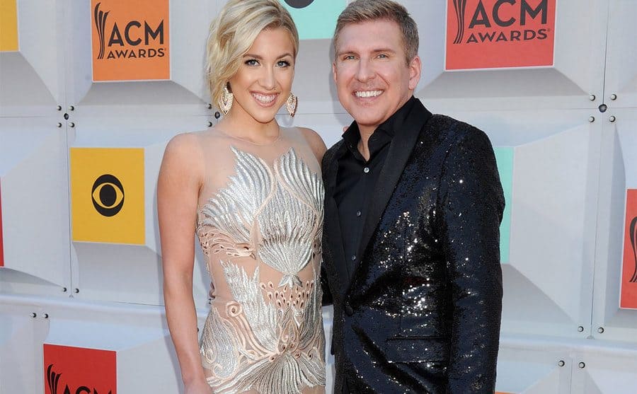 Savannah Chrisley and Todd Chrisley standing together in a music awards ceremony 