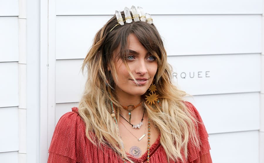 Paris Jackson on the red carpet with a headband made with crystals in it 